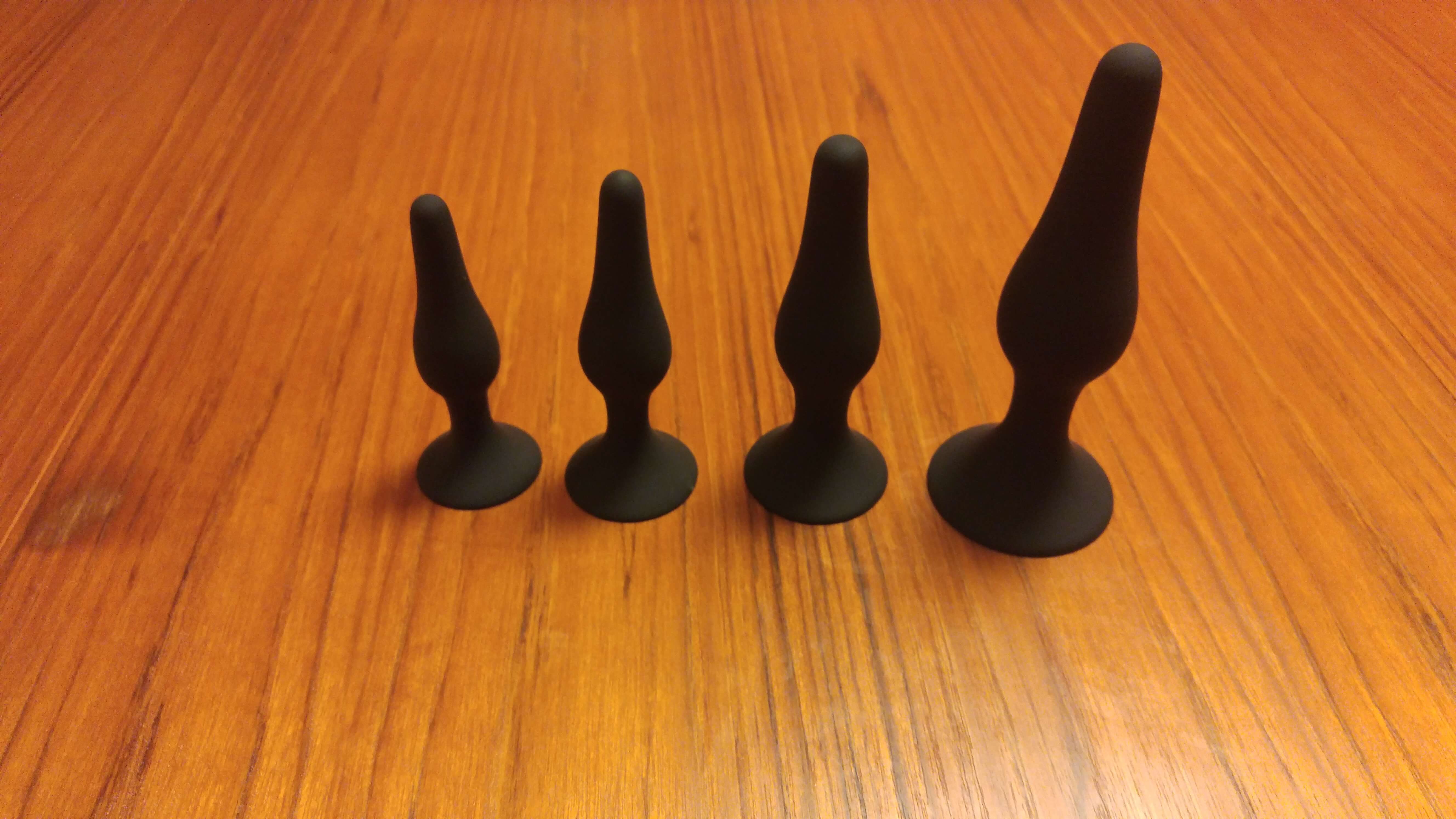 set of four black butt plugs