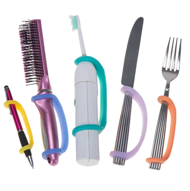 A pen, a brush, a toothbrush, a knife and a fork all with an EazyHold Univeral Cuff attached.