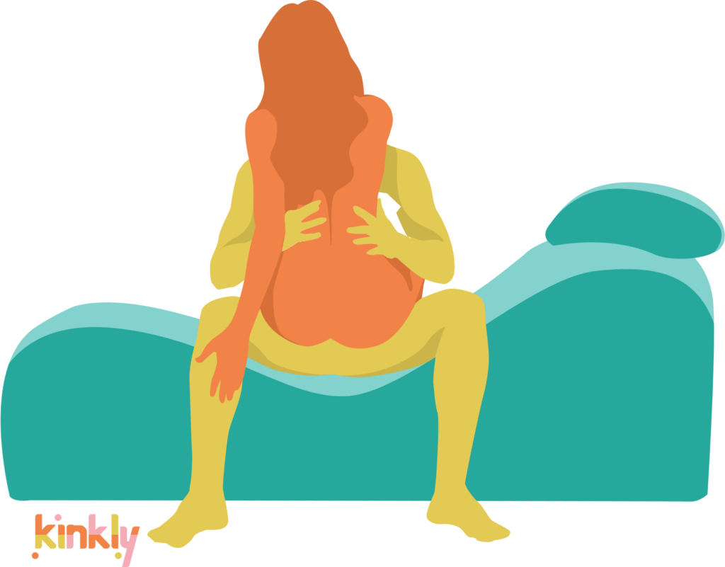 The penetrating partner is seated sideways on the lowest part of the sex chaise. They are using the sex chaise similarly to a chair. The receiving partner is straddling the penetrating partner's lap for penetration, facing the penetrating partner. | Kinkly