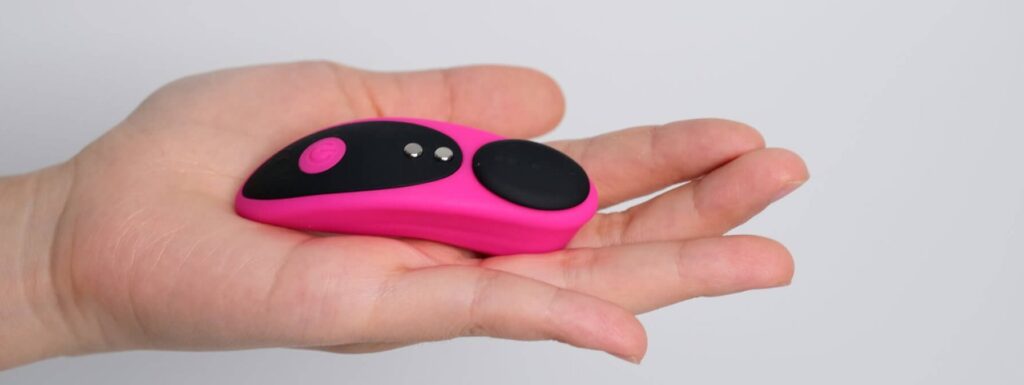Lovense Ferri held in the palm of a person's hand against a plain white background. The vibe is slender compared to the person's palm. | Kinkly Shop