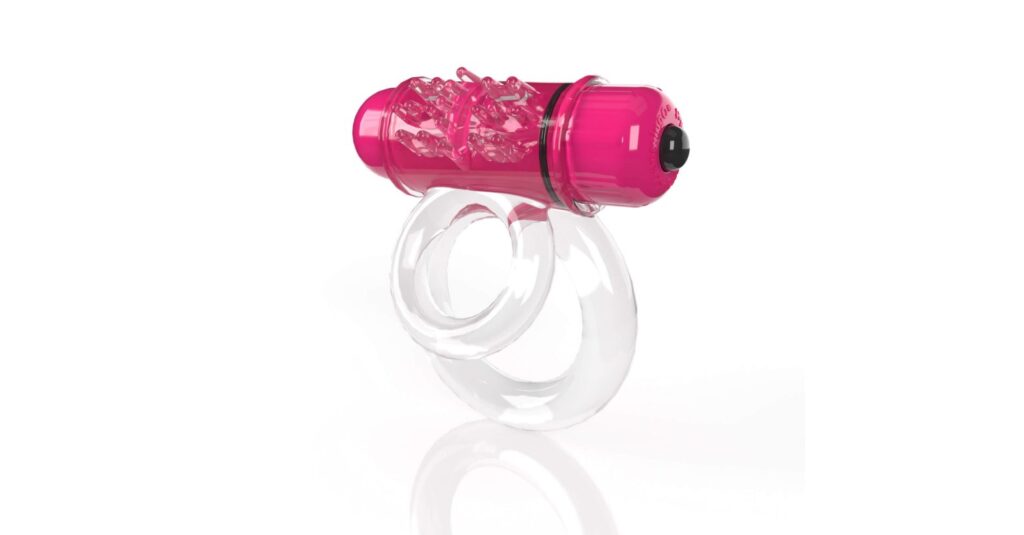 3/4ths angle of the Screaming O 4B DoubleO 6 in Strawberry. This showcases the two rings built into the cock ring itself. The smaller ring is noticeably smaller than the wider ring. The texturing on the vibrator's sleeve can also be seen slightly protruding from the ring itself. | Kinkly Shop