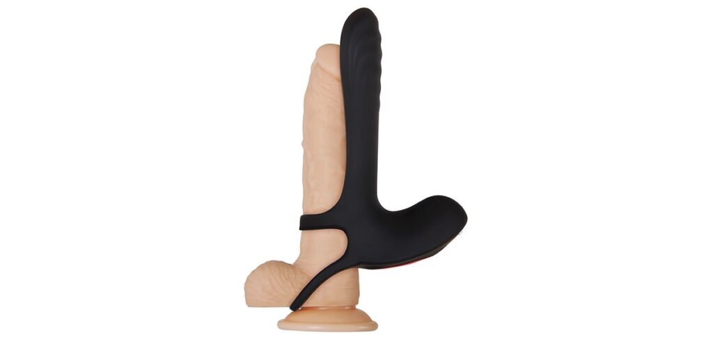 The Zero Tolerance Vibrating Girth Enhancer Extension is strapped onto a realistic-looking sand-color dildo. This shows the stability straps for the penis vibrator along the base of the shaft and beneath the testicles. | Kinkly Shop