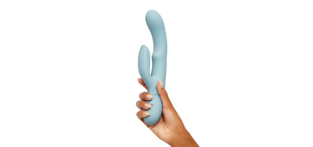 A hand holds the FemmeFunn Balai. The rabbit vibrator is much longer than the hand and would be much longer than the tip of the fingers to the base of the palm. The insertable shaft appears to be about as thick as three fingers. | Kinkly Shop